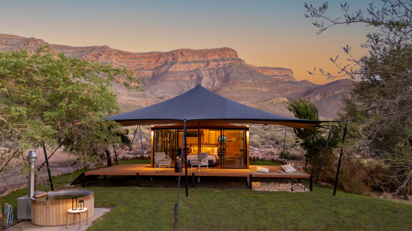 A warmly lit canvas hideaway beneath the Cederberg mountains at sunset